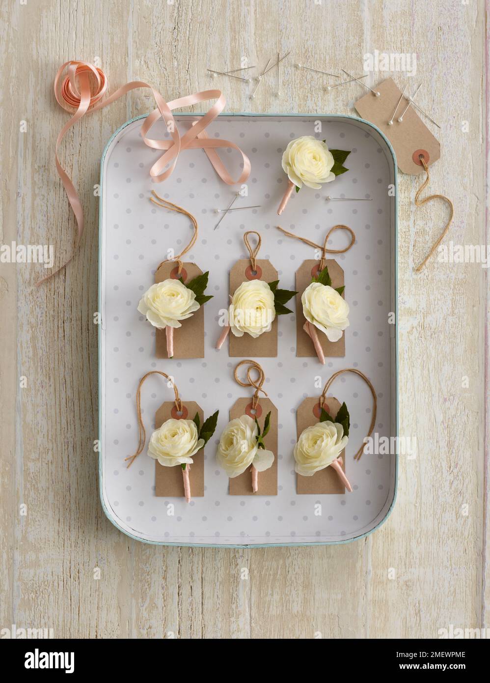 Papercraft. Butttonholes on wood background Stock Photo - Alamy