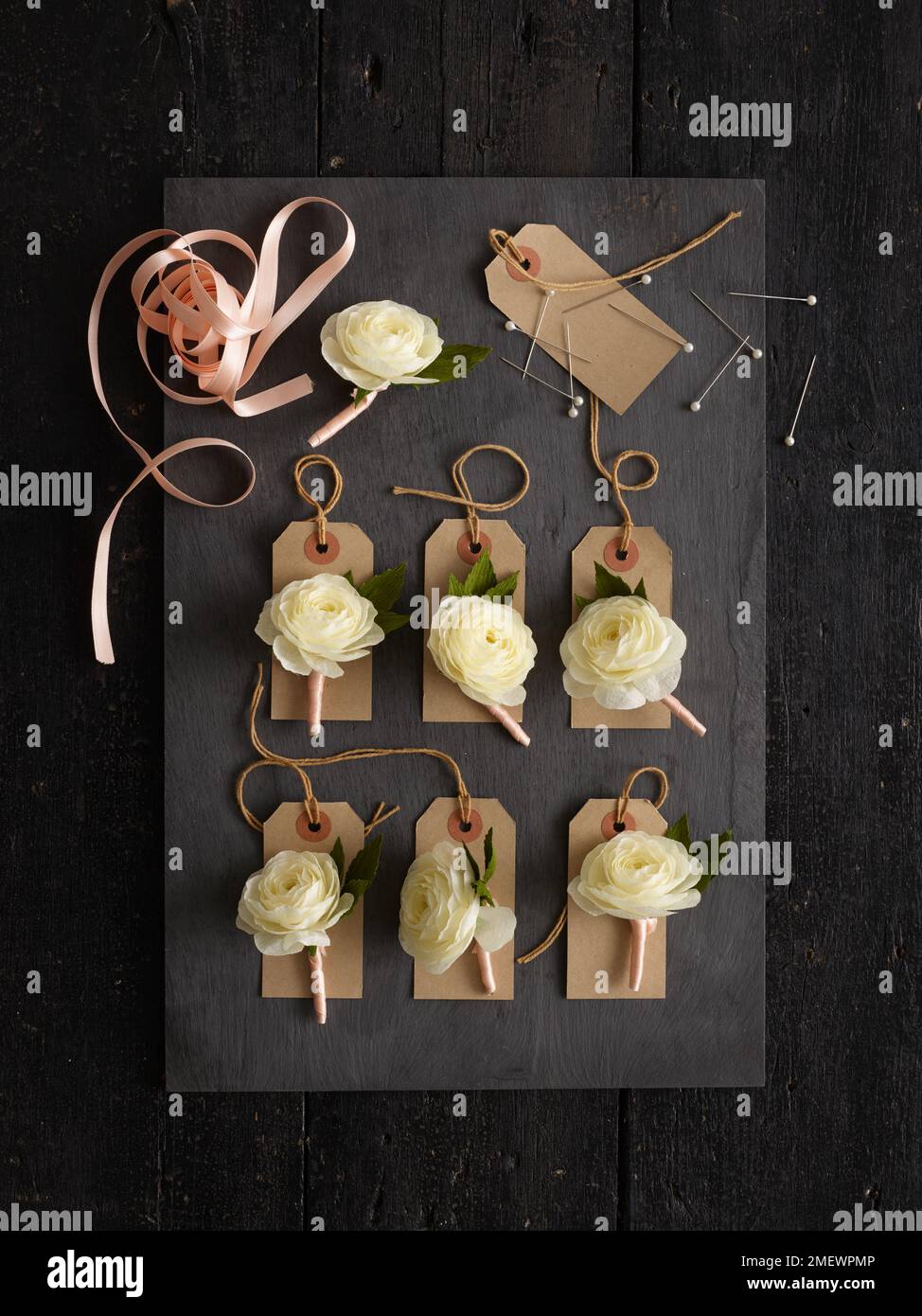 Papercraft. Butttonholes on black background Stock Photo - Alamy