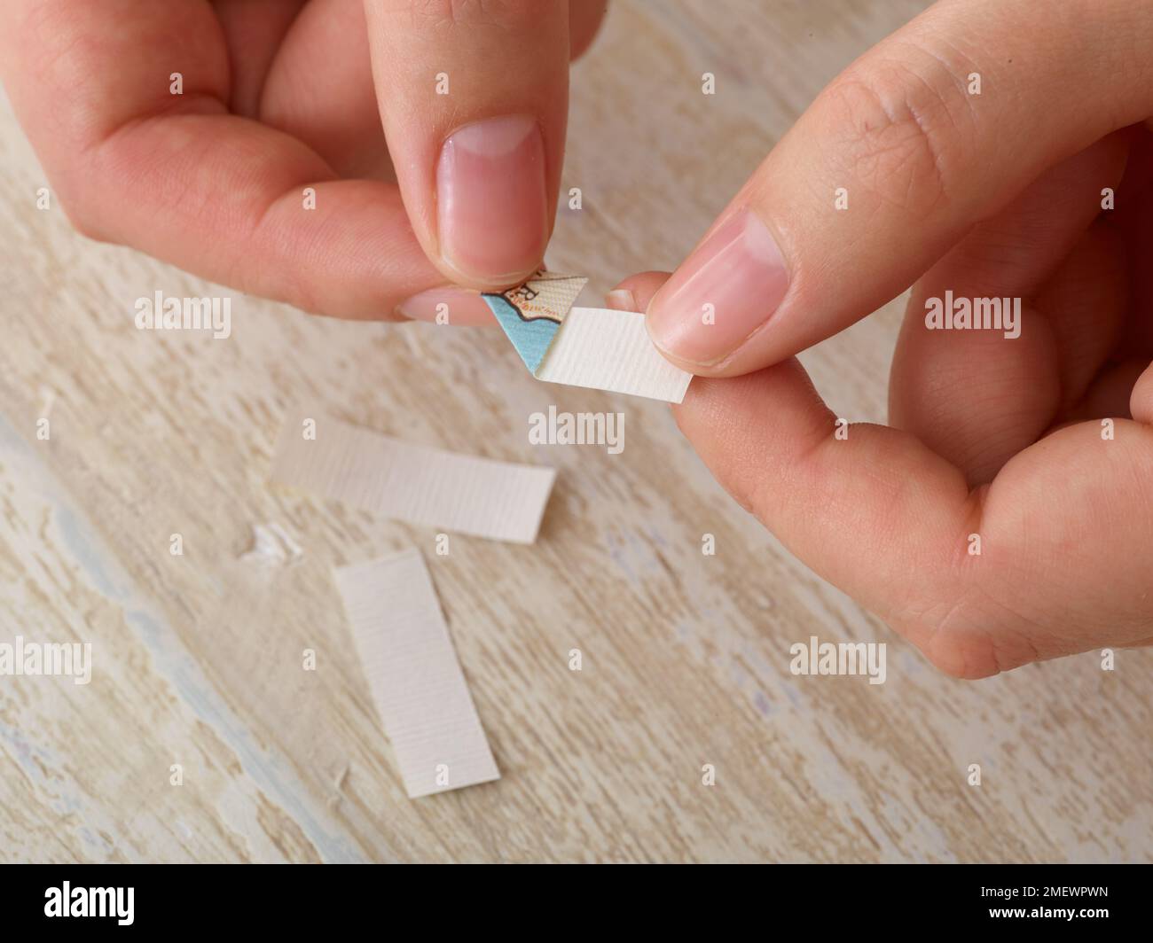 Papercraft. DIY Photo corners step 1. Fold corners of paper diagonally Stock Photo Alamy