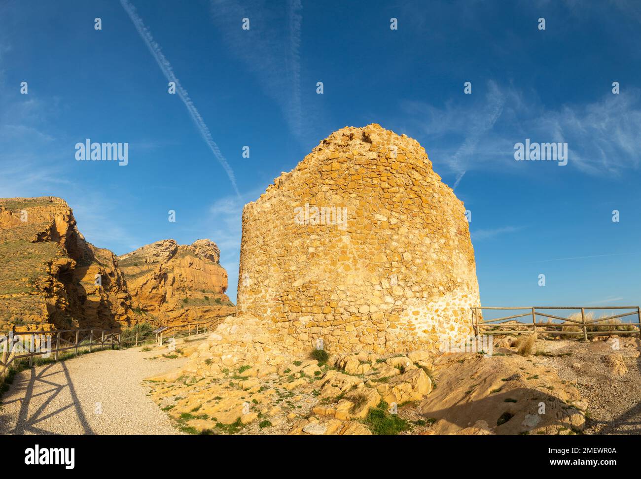 The Punta del Cavall,  a seventeenth century watchtower with Cliffs of the Sierra Helada behind , Benidorm, Spain Stock Photo