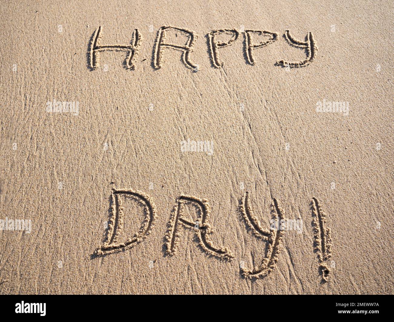 happy day words in sand with copy space Stock Photo