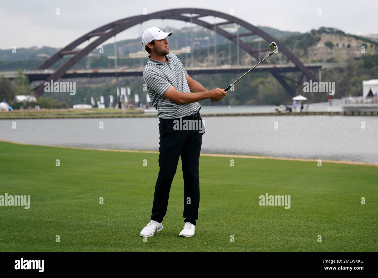 Scottie Scheffler watches his second shot from the No. 13 fairway