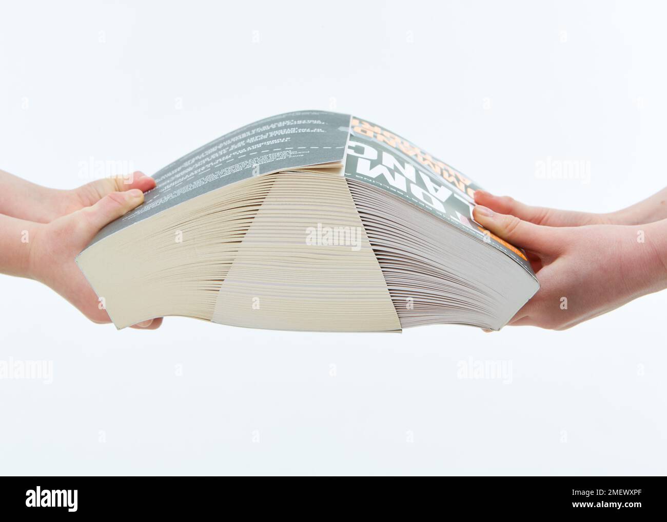 Children trying to pull two books with interleaved pages apart Stock Photo Alamy