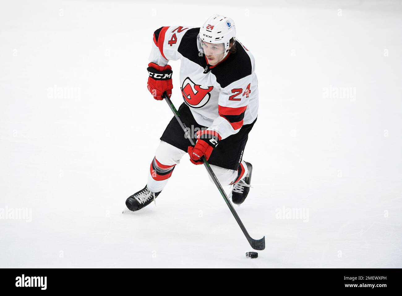 New Jersey Devils defenseman Ty Smith (24) skates with the puck