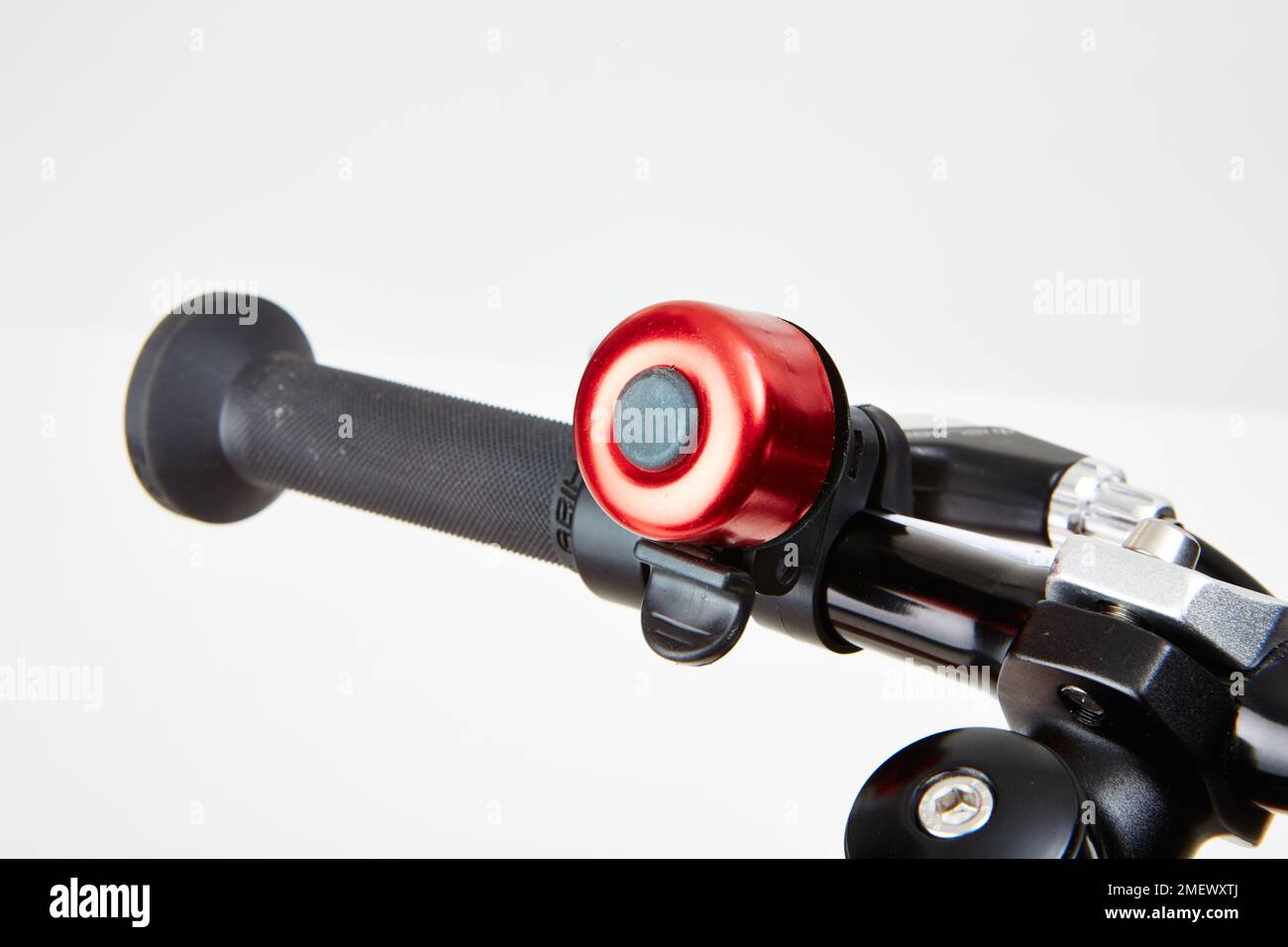 Red bike bell on handle bars Stock Photo