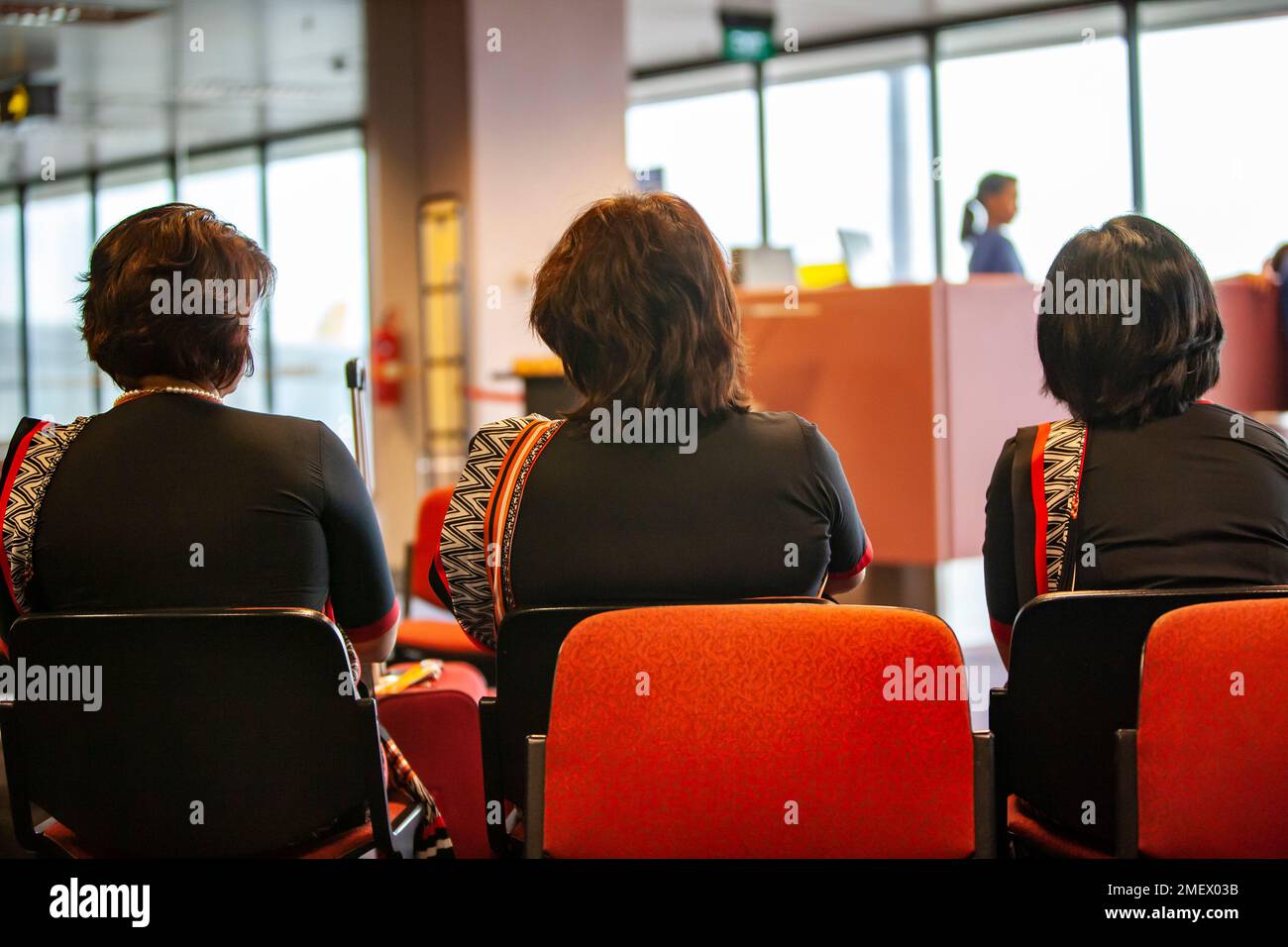 Saree clad air hostess aged sitting at airport Stock Photo