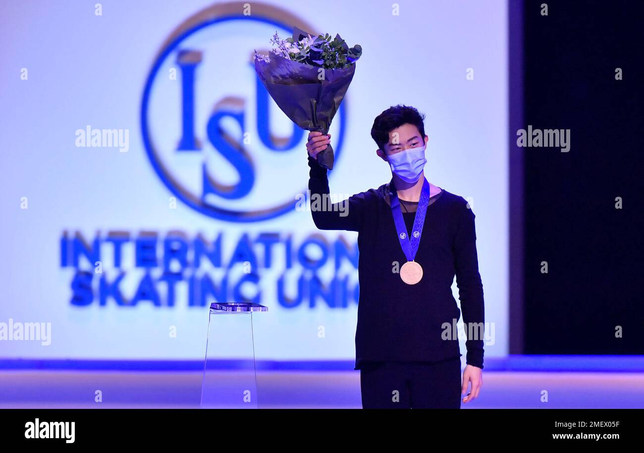 Nathan Chen of the USA stands on the podium after winning the gold