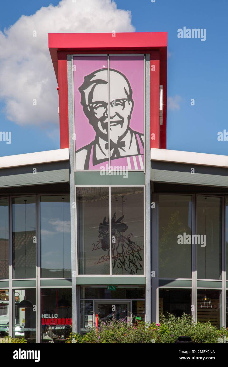 Colonel Sanders artwork featured on a KFC fast food restaurant. Kentucky Fried Chicken. Fast food, diet, healthy eating concept. Stock Photo