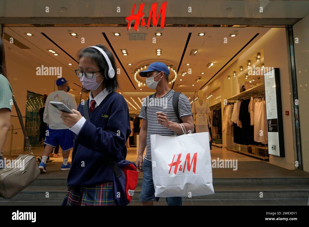 A man shops at an H&M clothing store in Hong Kong, Saturday, March 27,  2021. H&M disappeared from the internet in China as the government raised  pressure on shoe and clothing brands