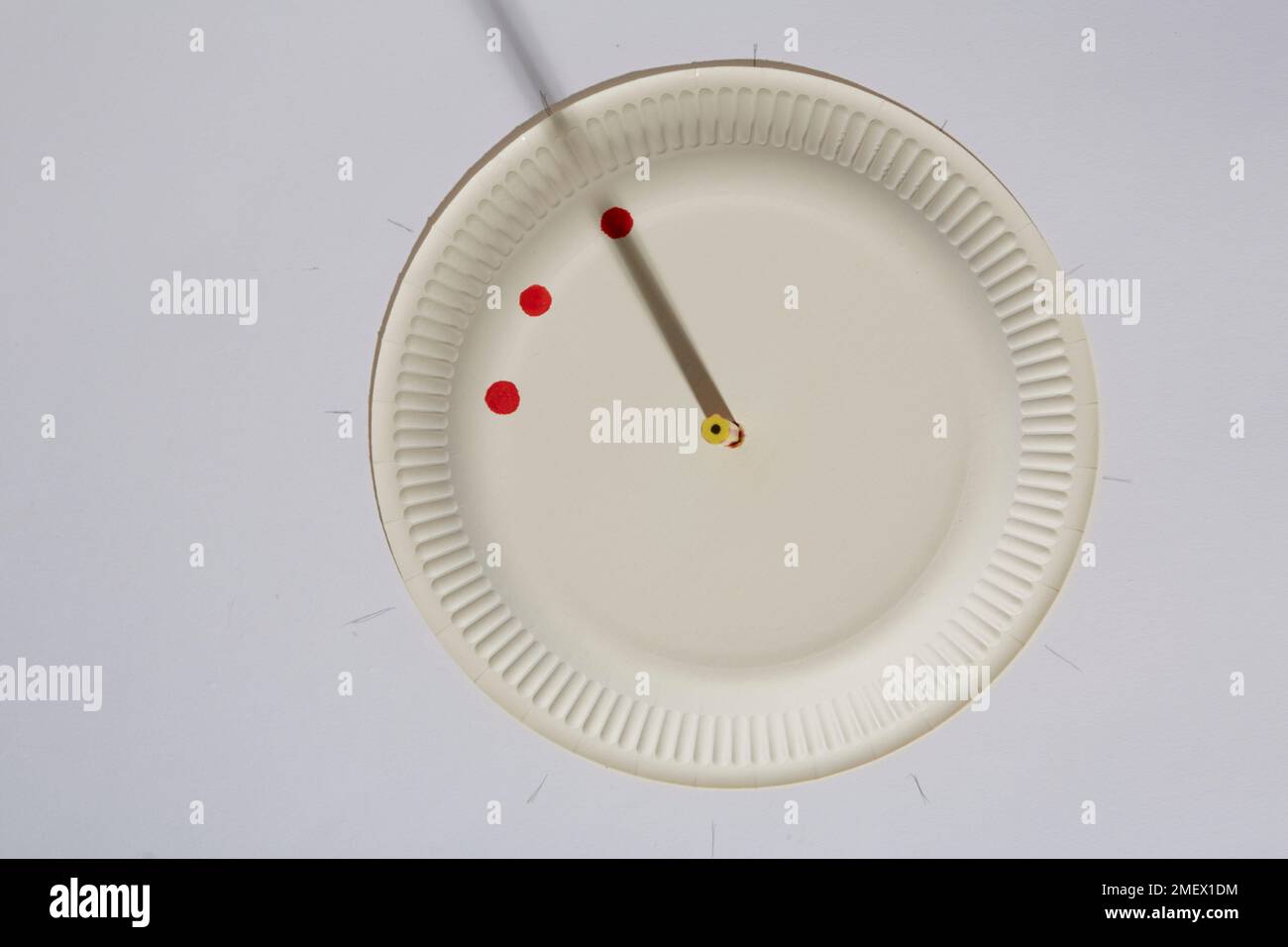 Creating a homemade sundial with a pencil and a paper plate Stock Photo