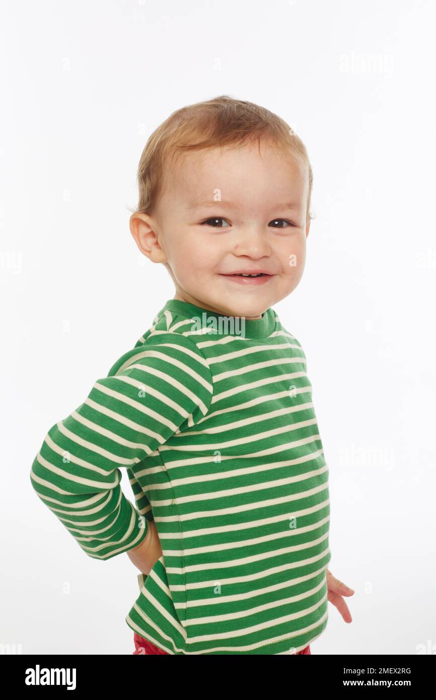 Little boy in green stripey top smiling (Model age - 22 months) Stock Photo