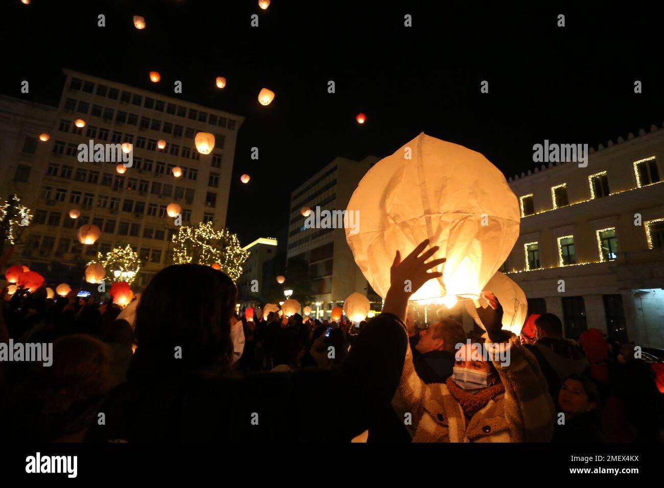 People light sky lanterns during the Christmas festivity 'Night ofWishes' outside the City Hall in Athens. Stock Photo