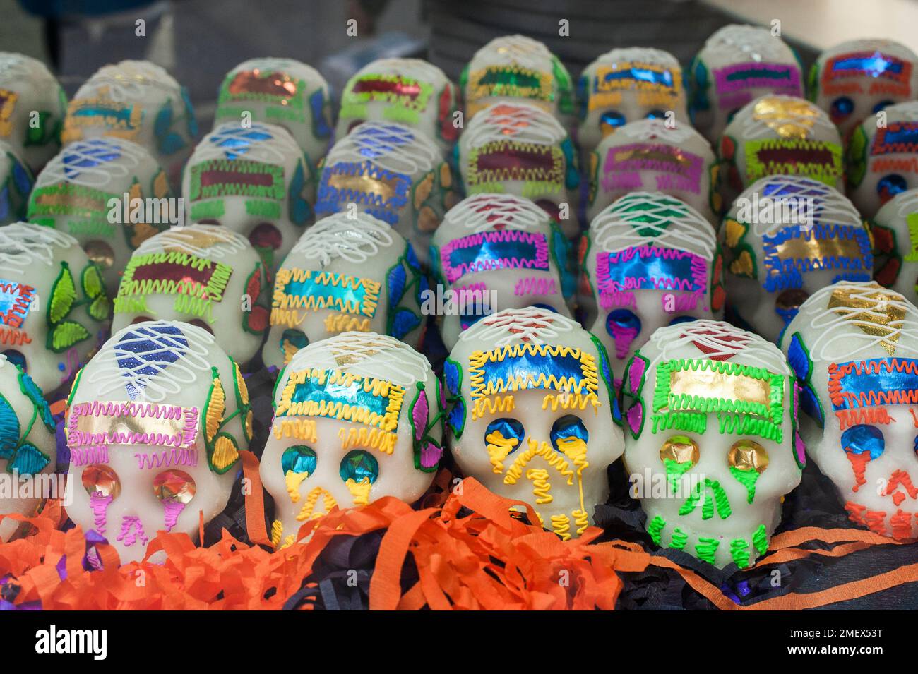 Colourful sugar skulls for sale on a stall at the Day of the Dead parade. Stock Photo