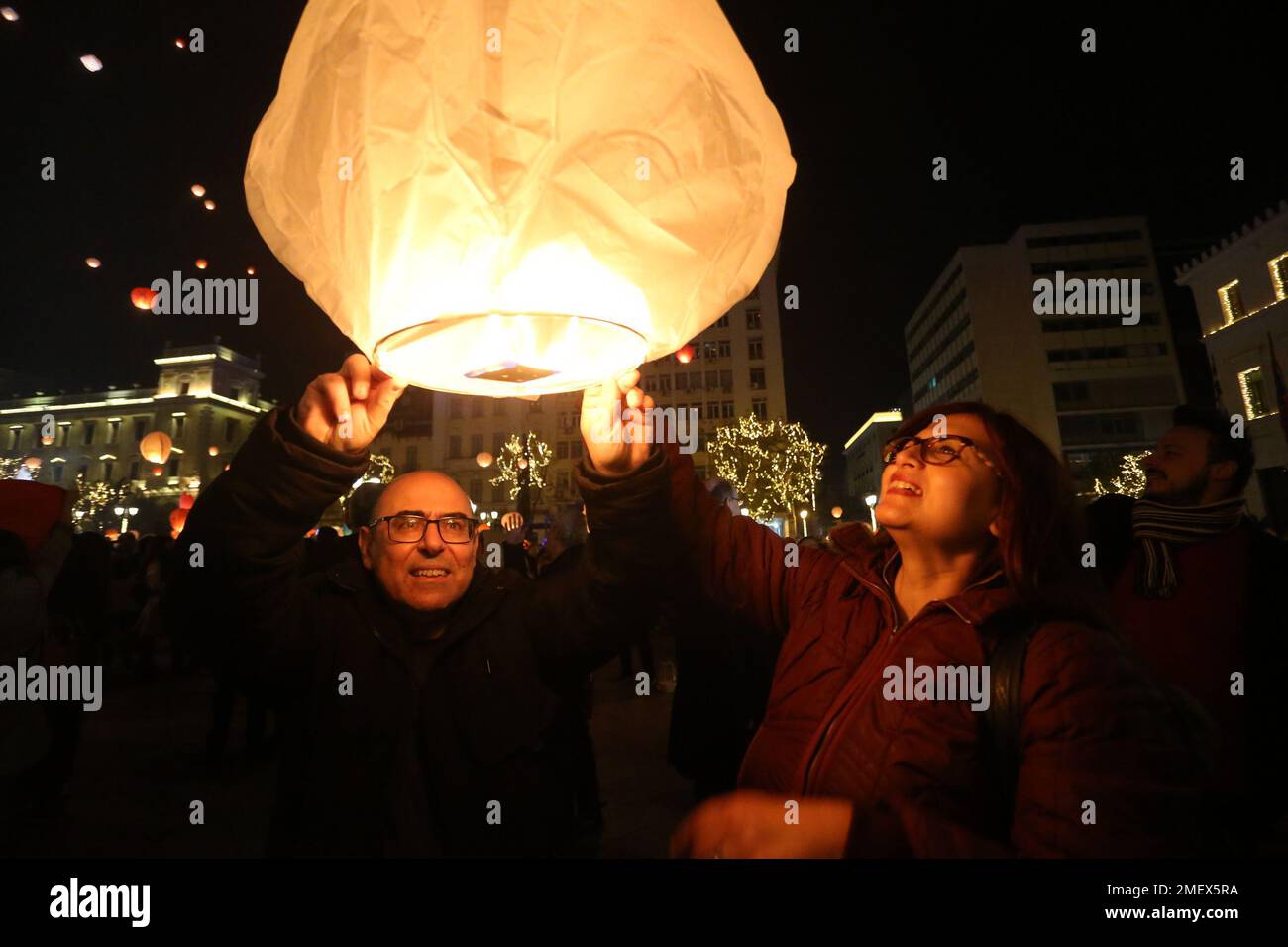 People light sky lanterns during the Christmas festivity 'Night ofWishes' outside the City Hall in Athens. Stock Photo