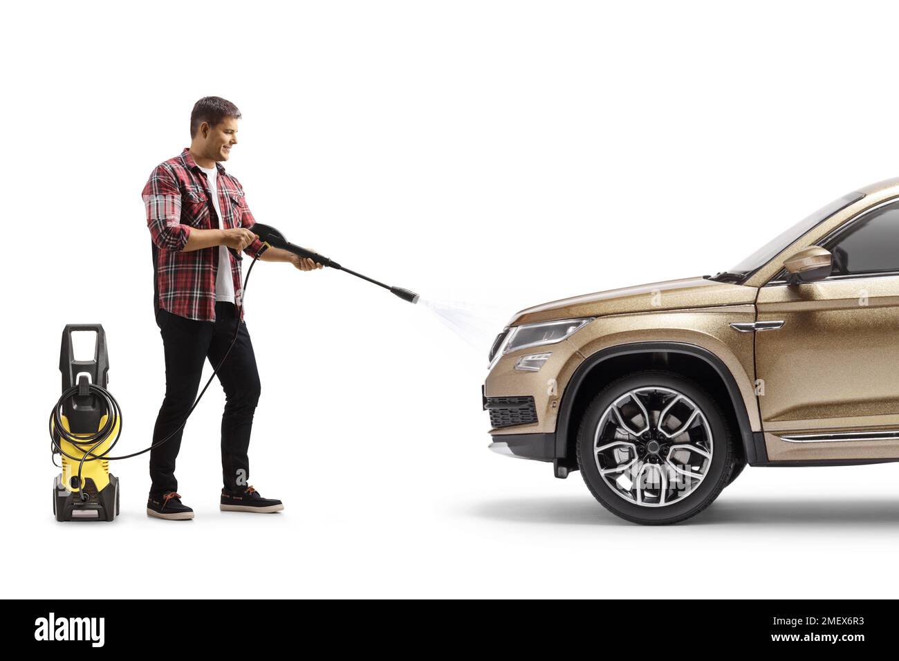 Young man cleaning a suv with a pressure washer machine isolated on