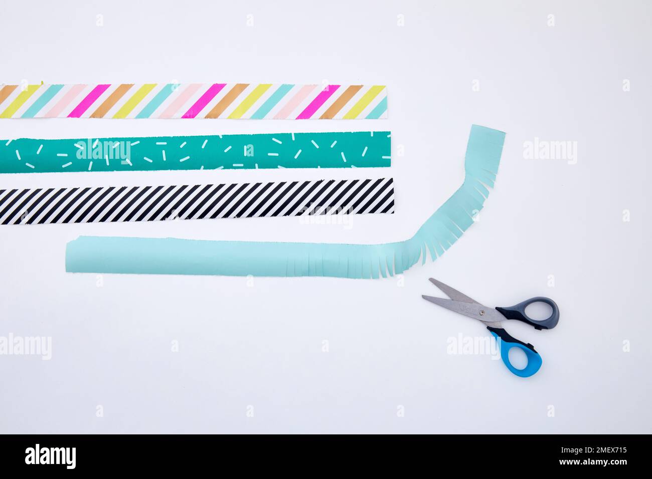 Pinata craft project Step 6 Cut strips of wrapping paper, add