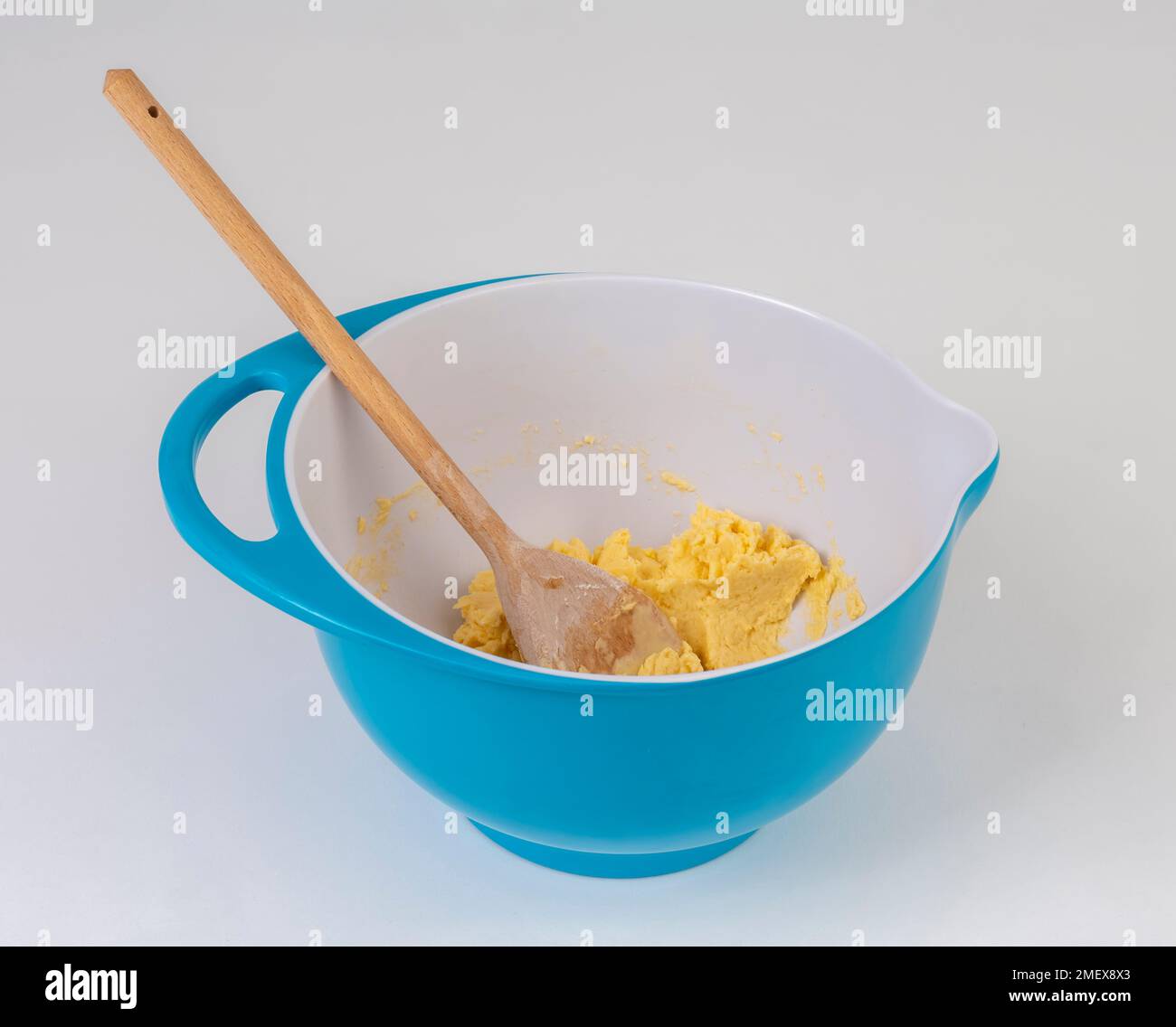 Mixing bowl with dough and wooden spoon on the table with tablecloth with  stripes. Homemade bread, in rustic style kitchen. Flat lay Stock Photo -  Alamy