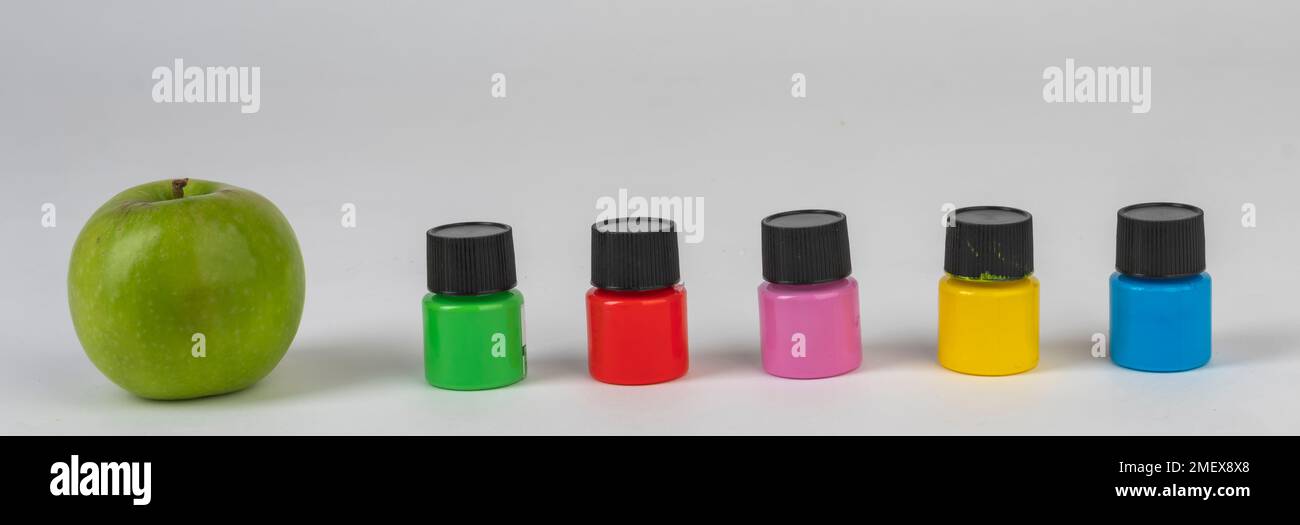 apple, coloured paint bottles Stock Photo Alamy