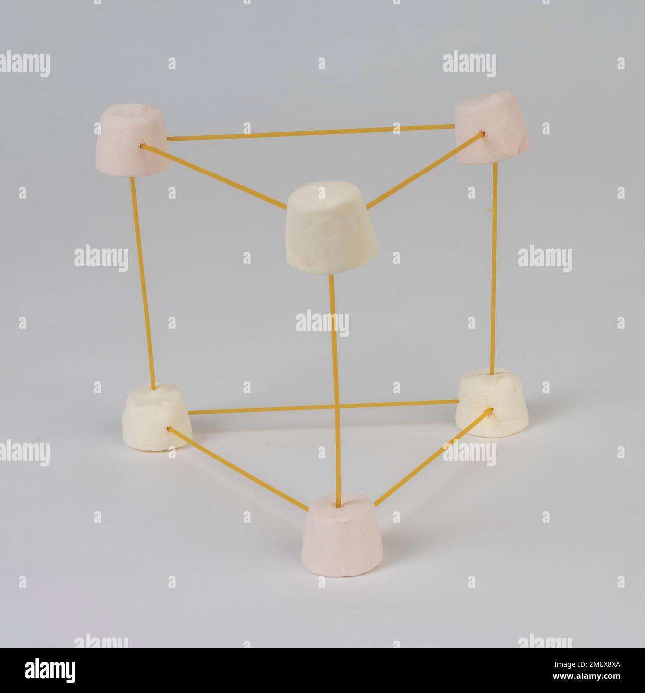 Marshmallow and spaghetti triangle with spaghetti prism shape Stock