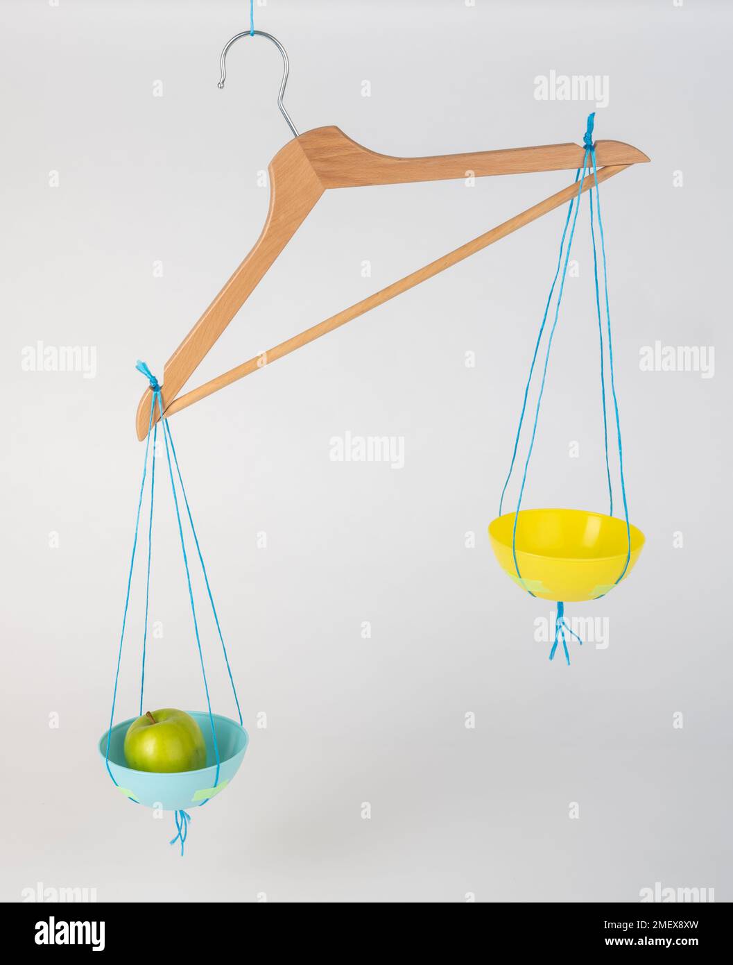 Coat hanger with hanging fruit Stock Photo Alamy