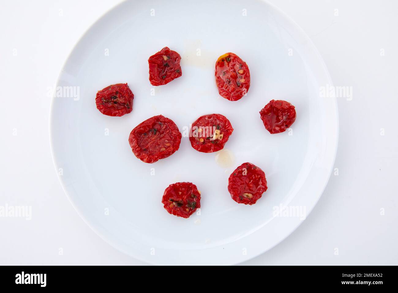 Sundried cherry tomatoes overhead on white background Stock Photo