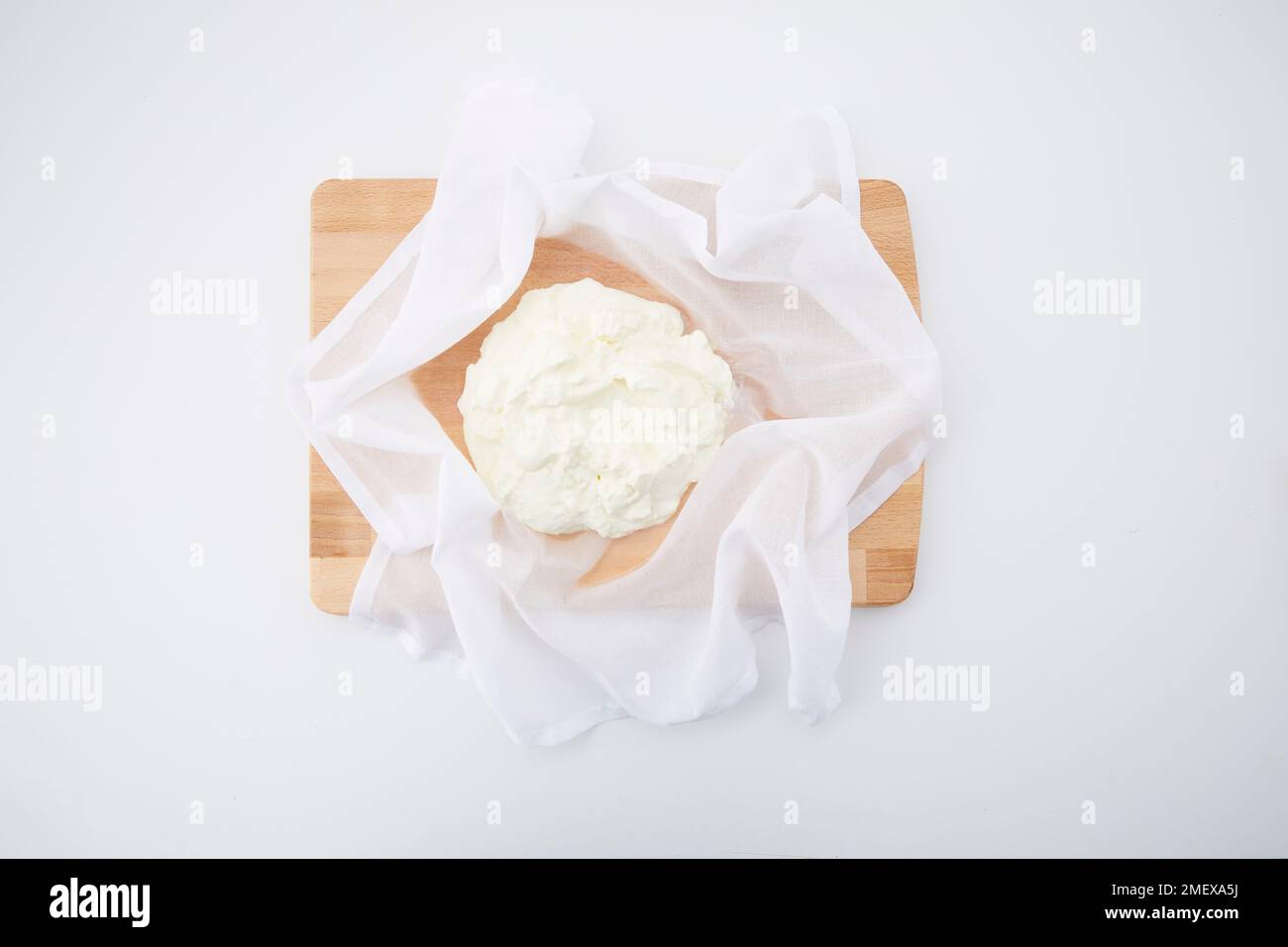 Labneh preparation Step 1 Greek yoghurt spooned into cheese cloth