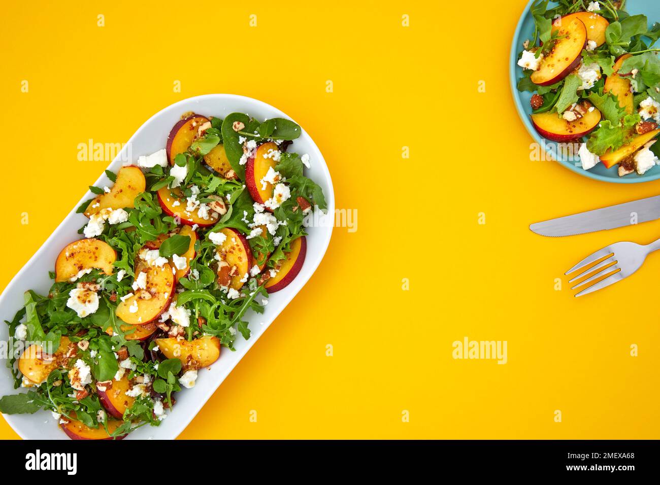 Nectarine and feta salad overhead on yellow background Stock Photo