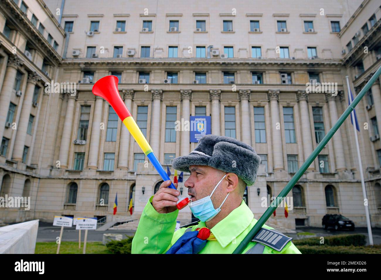 Ioan Canarau, the Vice President of Europol police union blows a horn  outside the interior ministry during a rally in Bucharest, Romania,  Thursday, March 25, 2021. Hundreds of police and retired military