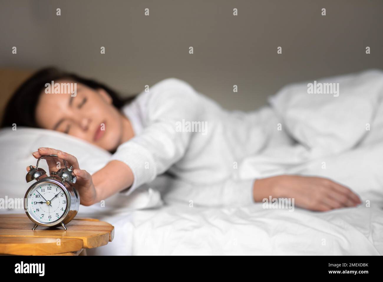 Tired sad unhappy young european woman in pajamas wake up, turns off
