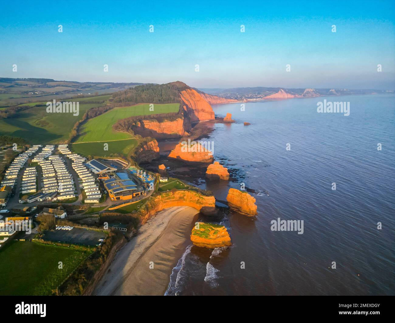 Ladram Bay, Otterton, UK.  24th January 2023.  UK Weather.   View from the air of the red sandstone sea stacks and cliffs at Ladram Bay at Otterton near Sidmouth in Devon on a cold sunny afternoon.  Picture Credit: Graham Hunt/Alamy Live News Stock Photo