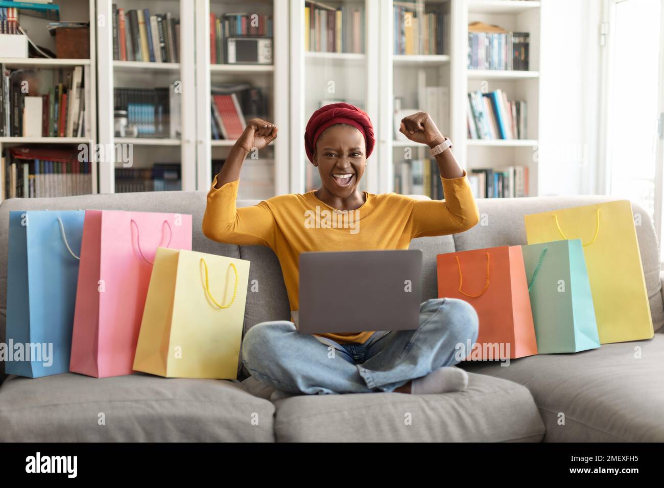 Emotional african american female consumer shopping from home, using computer Stock Photo Alamy
