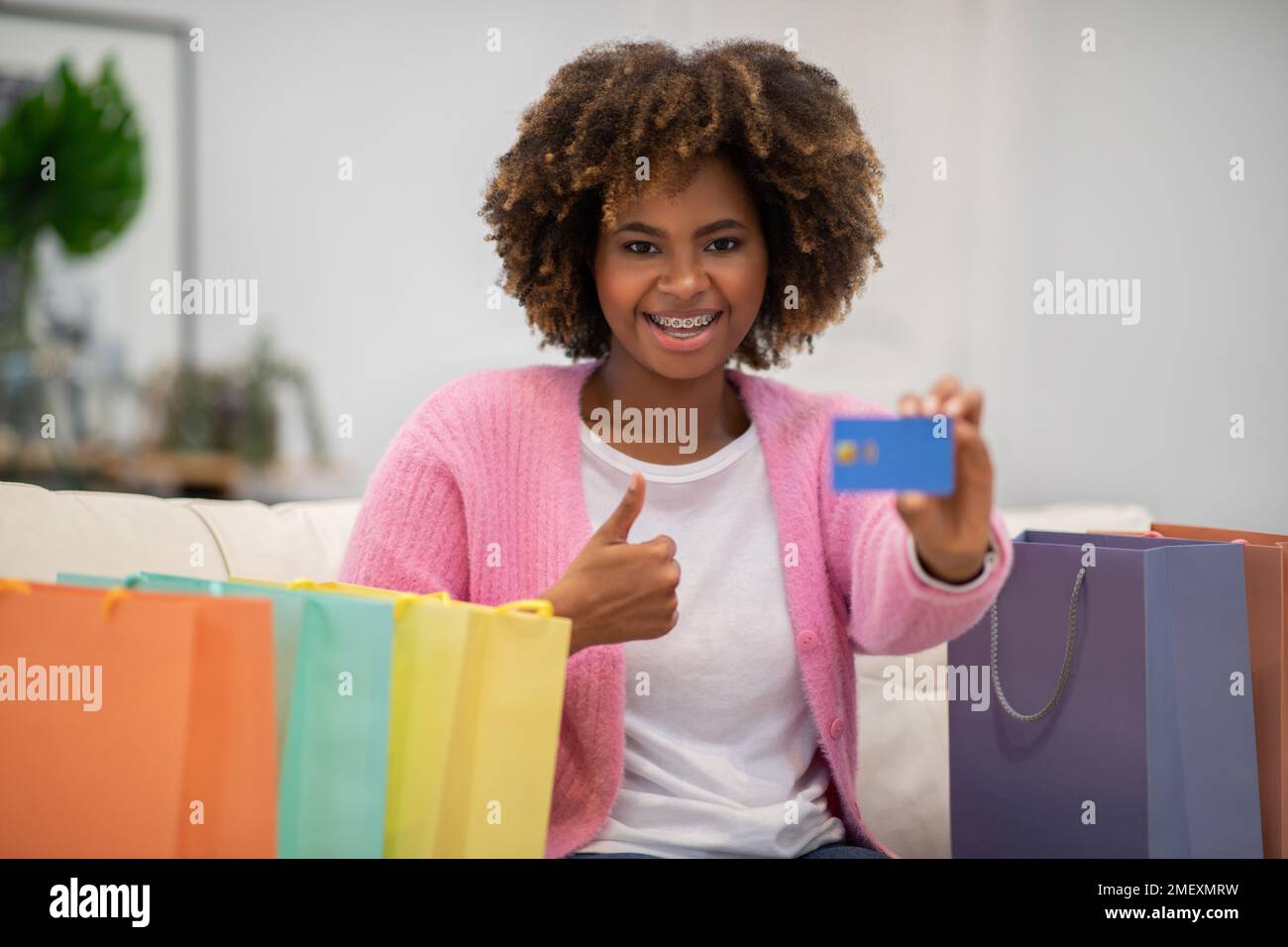 Overjoyed young black woman customer shopping from home Stock Photo