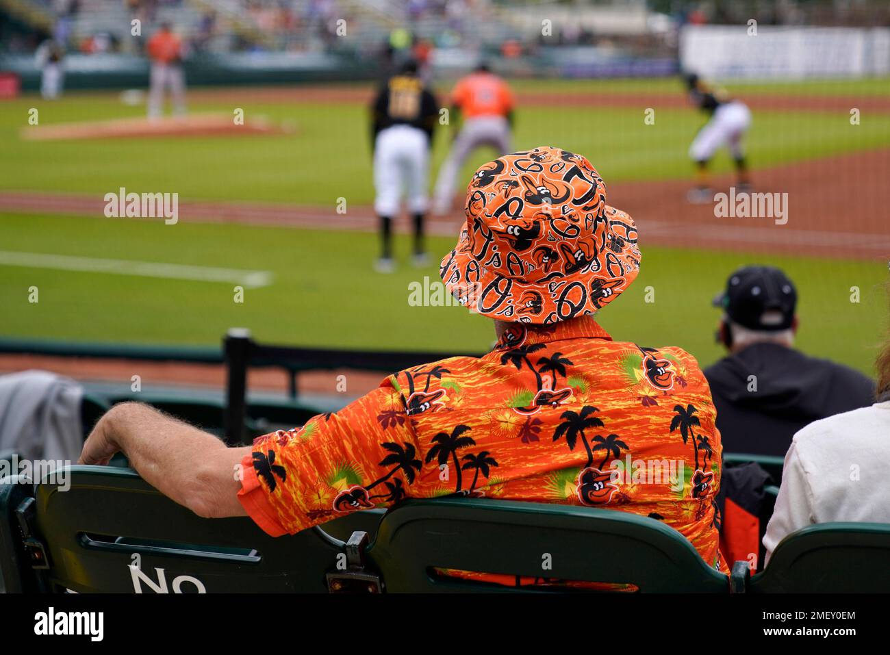 Baltimore Orioles fan Bob Kominski, center, of Mt. Lebanon, Pa., watches a  spring training exhibition baseball game between the Pittsburgh Pirates and  the Baltimore Orioles in Bradenton, Fla., Monday, March 22, 2021. (