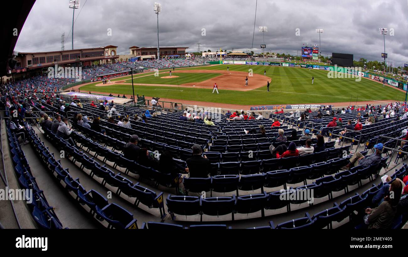 A limited number of socially distanced baseball fans watch a spring training exhibition baseball