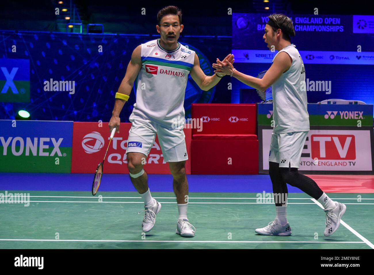 Japans Takeshi Kamura, right, and Keigo Sonoda shake hands during the mens doubles final match of the All England Open Badminton Championships against Japans Yuta Watanabe and Hiroyuki Endo at the Utilita