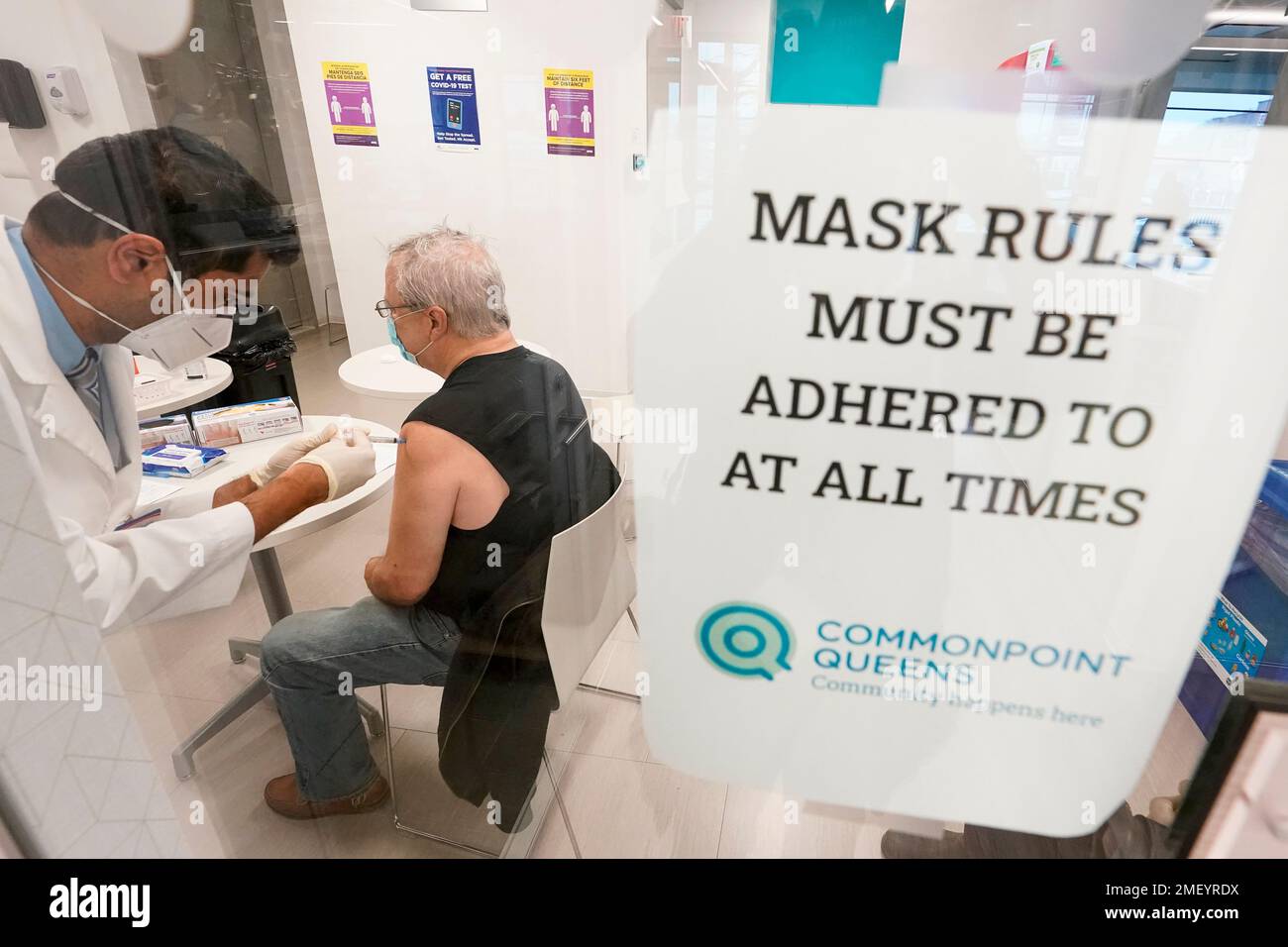 Pharmacist Ambar Keluskar inoculates a patient with the first dose of the Moderna COVID19