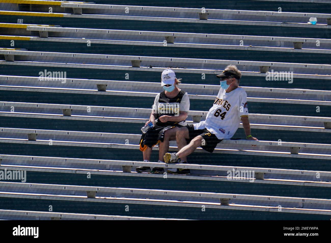 Socially distanced Pittsburgh Pirates fans sit in the bleachers during a spring training