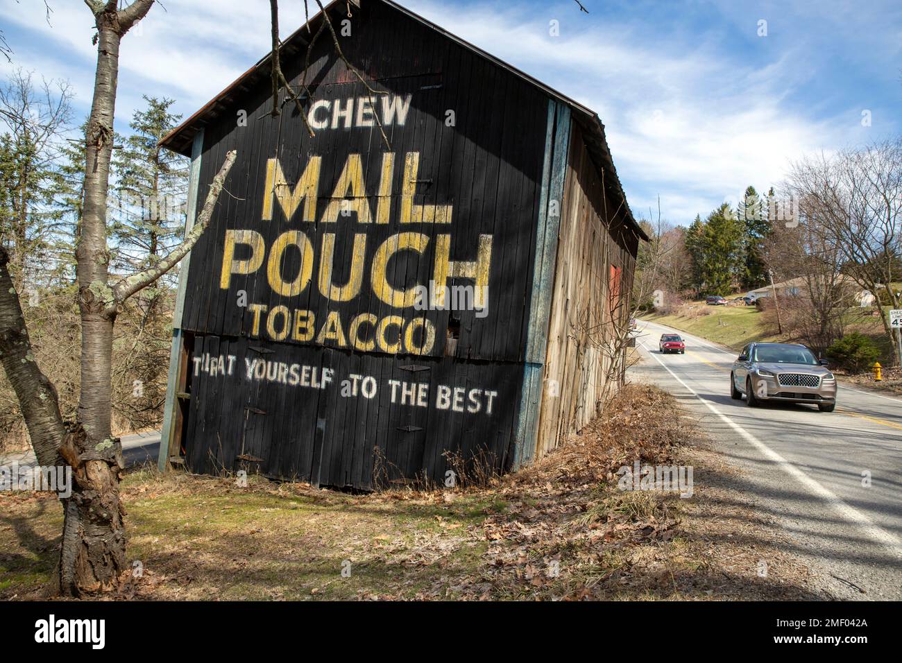 A chewing tobacco advertisement for Mail Pouch Tobacco is on the side of an  old barn in McDonald, Pennsylvania, on Monday, March 15, 2021. (AP  Photo/Ted Shaffrey Stock Photo