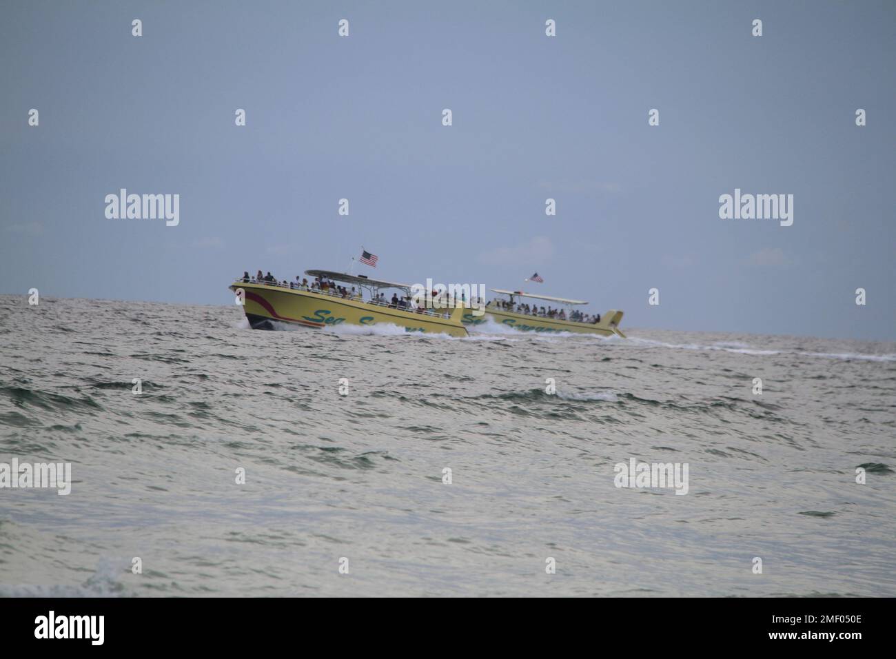 Panama City Beach, FL, USA. Boat tours on a wavy sea in a cloudy day ...