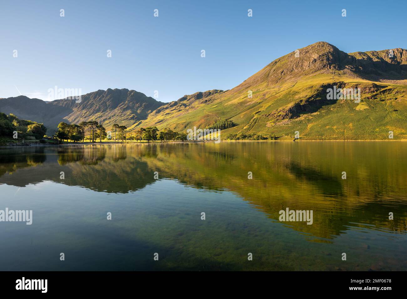 Lake District mountains reflecting in calm water at Buttermere. Stock Photo