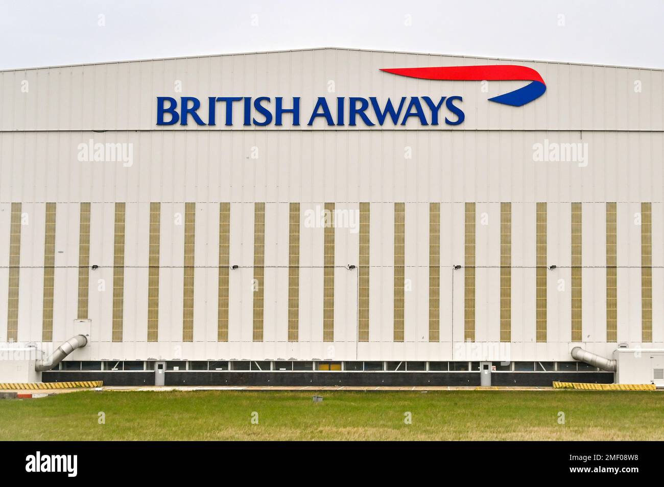 London, England - April 2022: Exterior view of a large aircraft maintenance hangar at Heathrow Airport used by British Airways Stock Photo