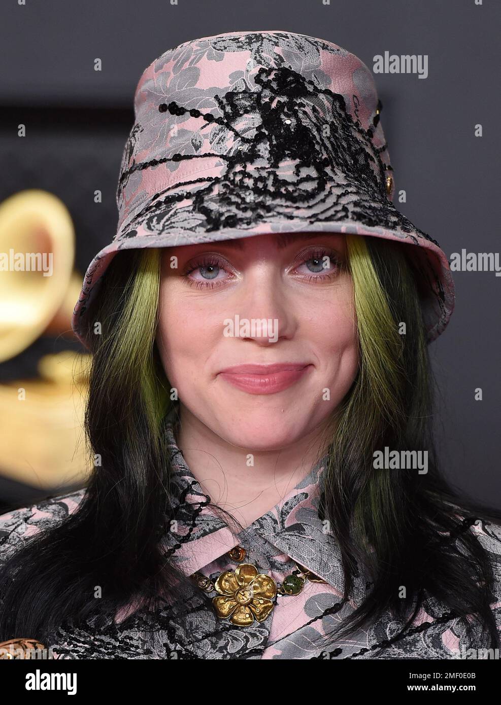 Billie Eilish poses in the press room with the awards for best song