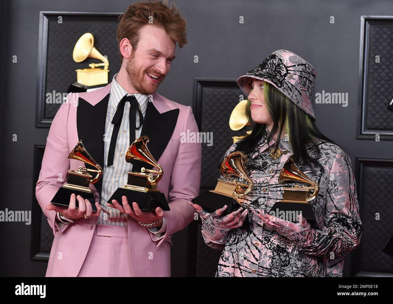 Finneas, left, and Billie Eilish pose in the press room with the awards