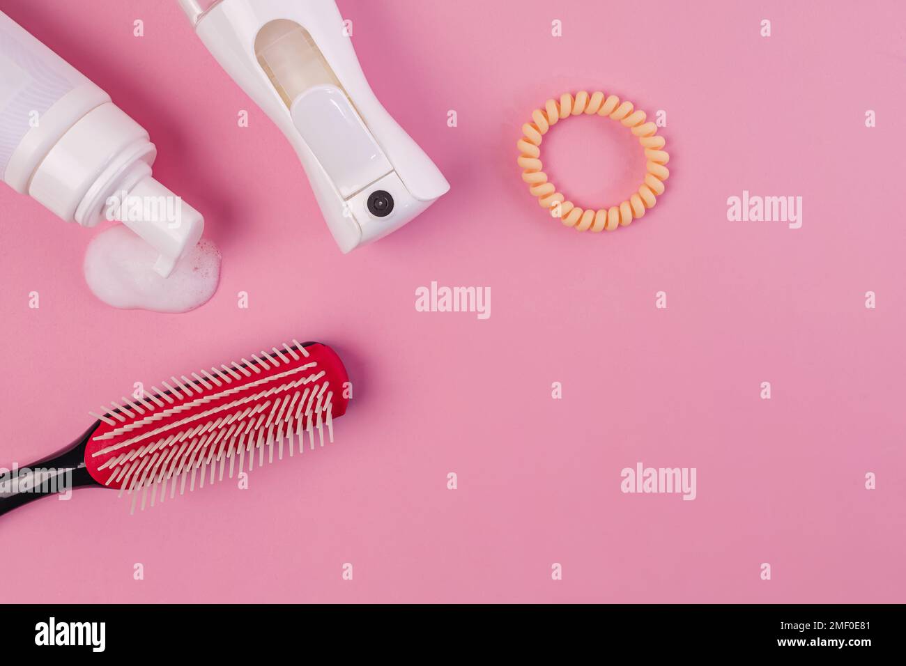 Brush, water spray bottle, curl styling mousse. Products for styling