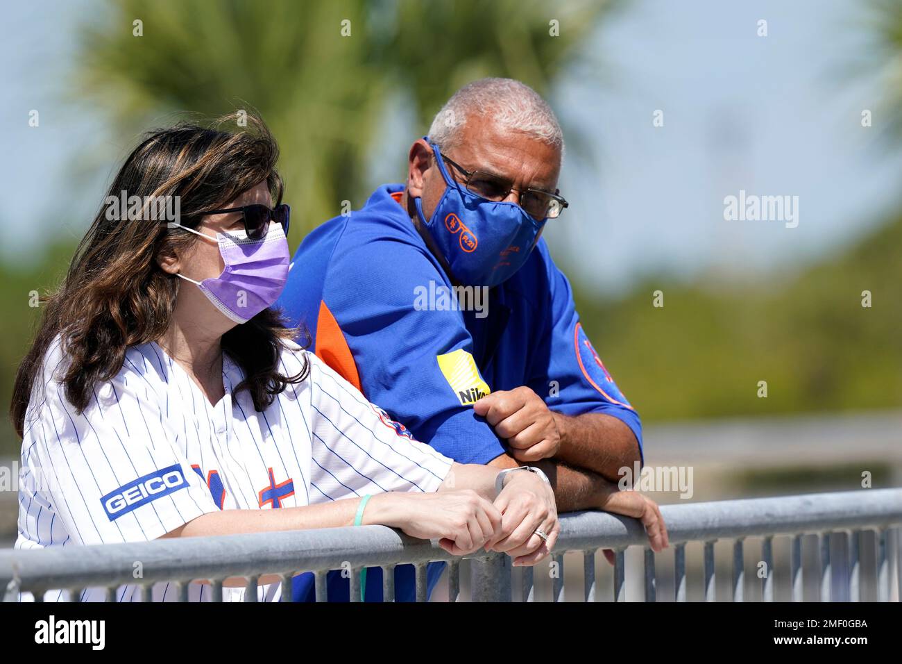 New York Mets fans watch players warm up before a spring training baseball game against the St. Louis Cardinals, Sunday, March 14, 2021, in Port St