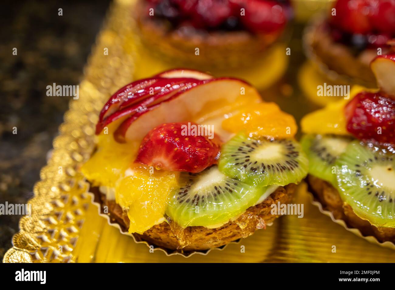 Delicious fresh baked colorful decorated cakes, tarts with cream and ...
