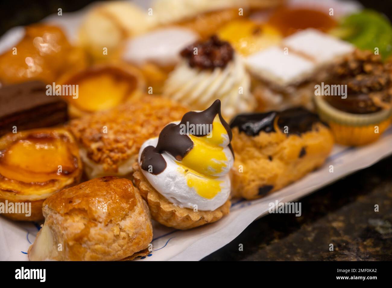 Delicious fresh baked colorful decorated cakes, tarts with cream and ...