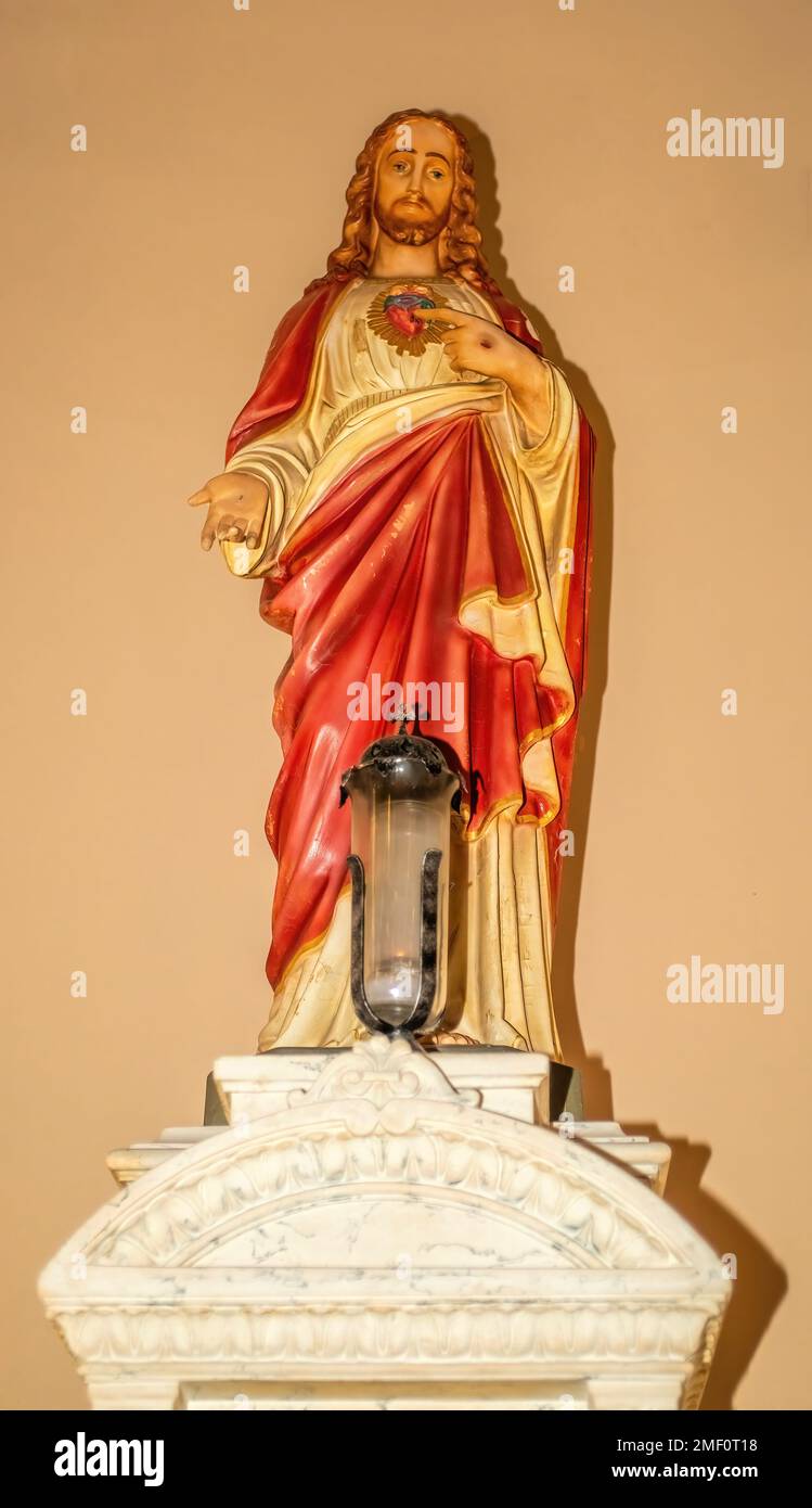 Statue of the Sacred Heart of Jesus and candle at the historic 1894