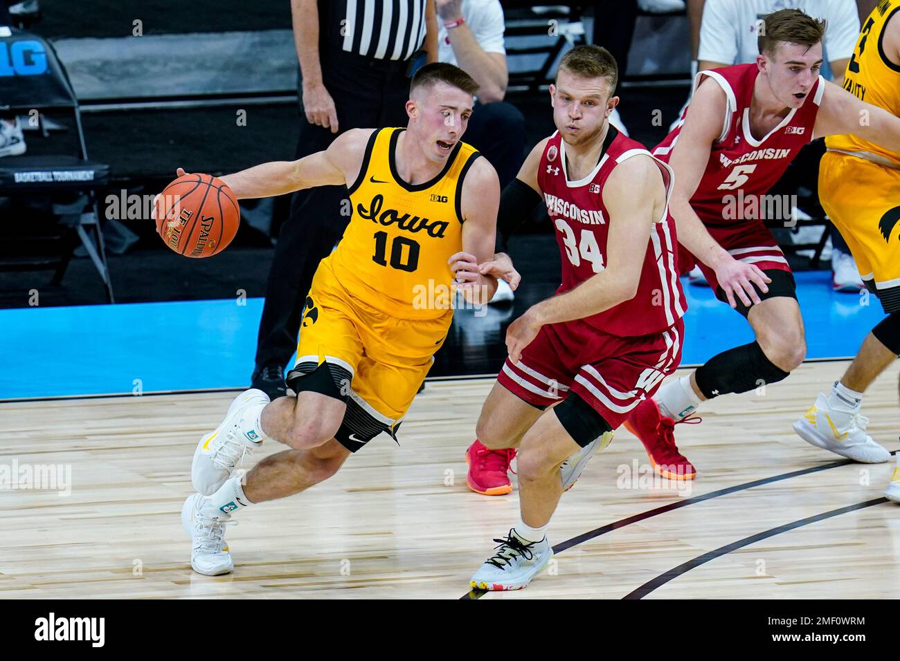 Iowa guard Joe Wieskamp (10) drives on Wisconsin guard Brad Davison (34