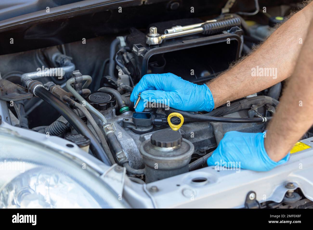 Ignition coil or car spark plug change or replacement. Repairing of vehicle engine Stock Photo